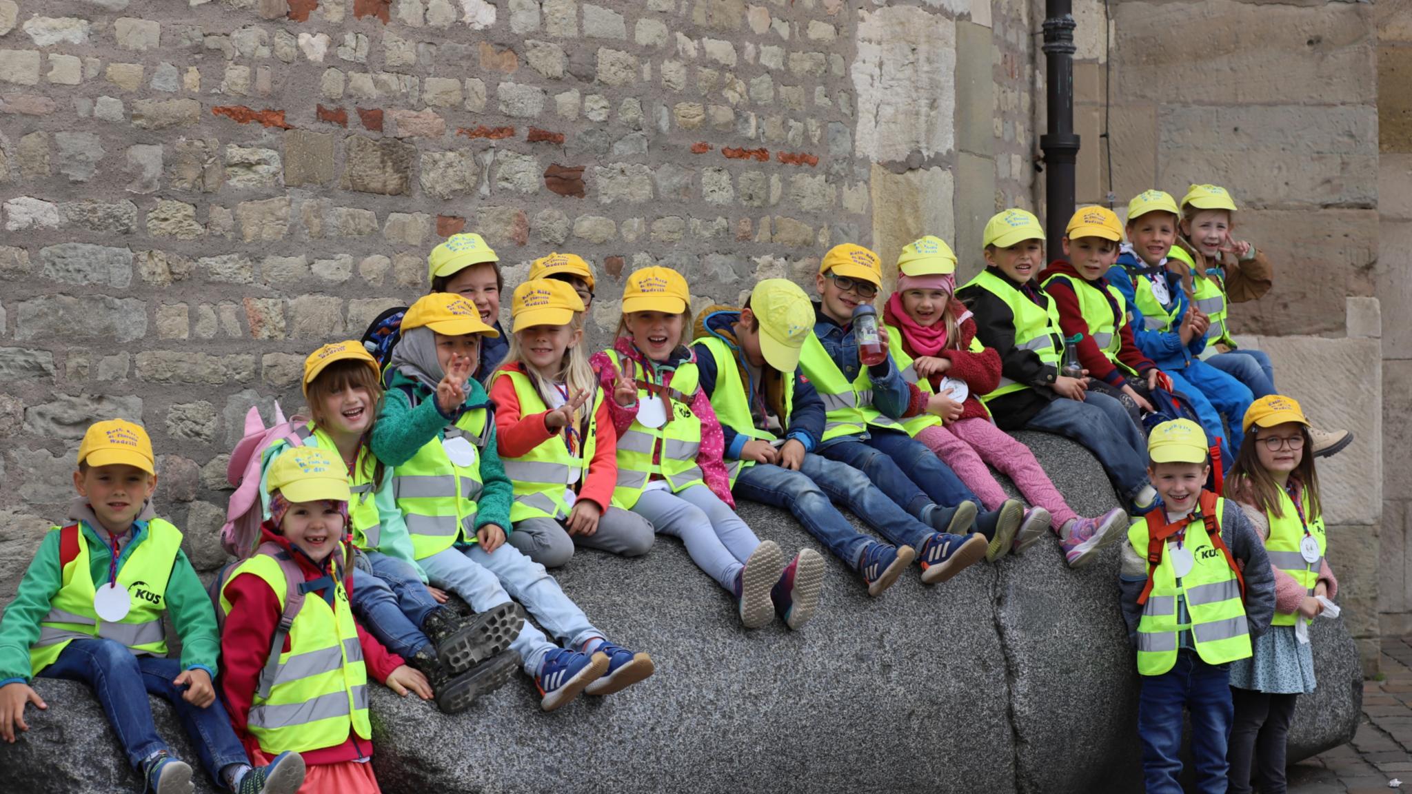 Kinder der Kita St. Theresia in Wadrill sitzen auf dem Domstein
